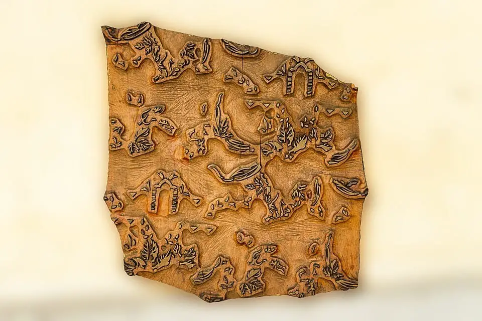An orange colored irregularly shaped map with tribal designs.