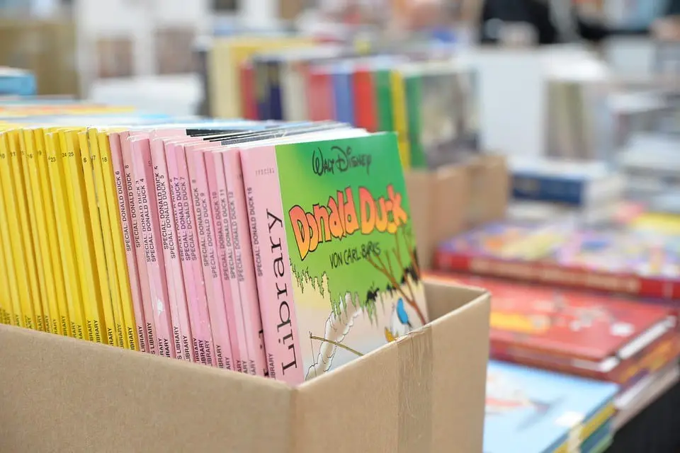 A cardboard box full of comic books kept in a bookstore.